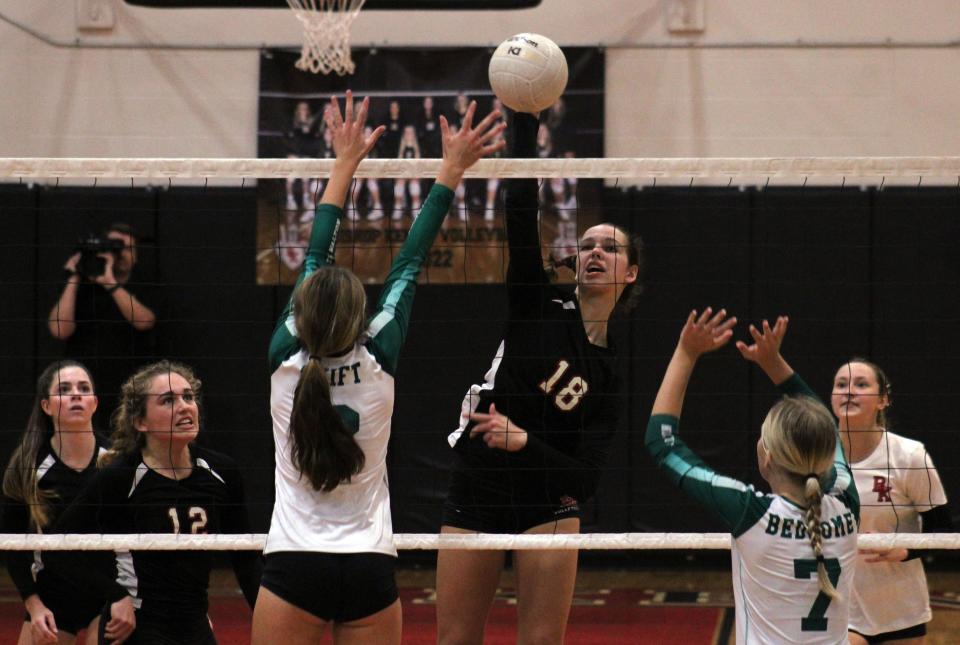 Bishop Kenny middle blocker Olivia Ryno (18) spikes the ball as South Walton's Jordyn Swift (2) and Danna Beddome (7) defend during the 2022 regional volleyball final. The FHSAA is exploring a change to a neutral-site final four for volleyball.