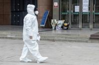 Medical staff walks past a makeshift memorial to the late ophthalmologist Li Wenliang at the Houhu Branch of Wuhan Central Hospital on February 7