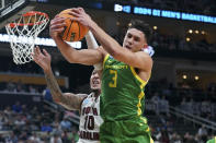 Oregon's Jackson Shelstad (3) pulls down a rebound against South Carolina's Myles Stute (10) during the first half of a first-round college basketball game in the NCAA Tournament, Thursday, March 21, 2024, in Pittsburgh. (AP Photo/Matt Freed)