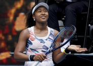 Japan's Naomi Osaka celebrates after defeating Marie Bouzkova of the Czech Republic in their first round singles match the Australian Open tennis championship in Melbourne, Australia, Monday, Jan. 20, 2020. (AP Photo/Lee Jin-man)