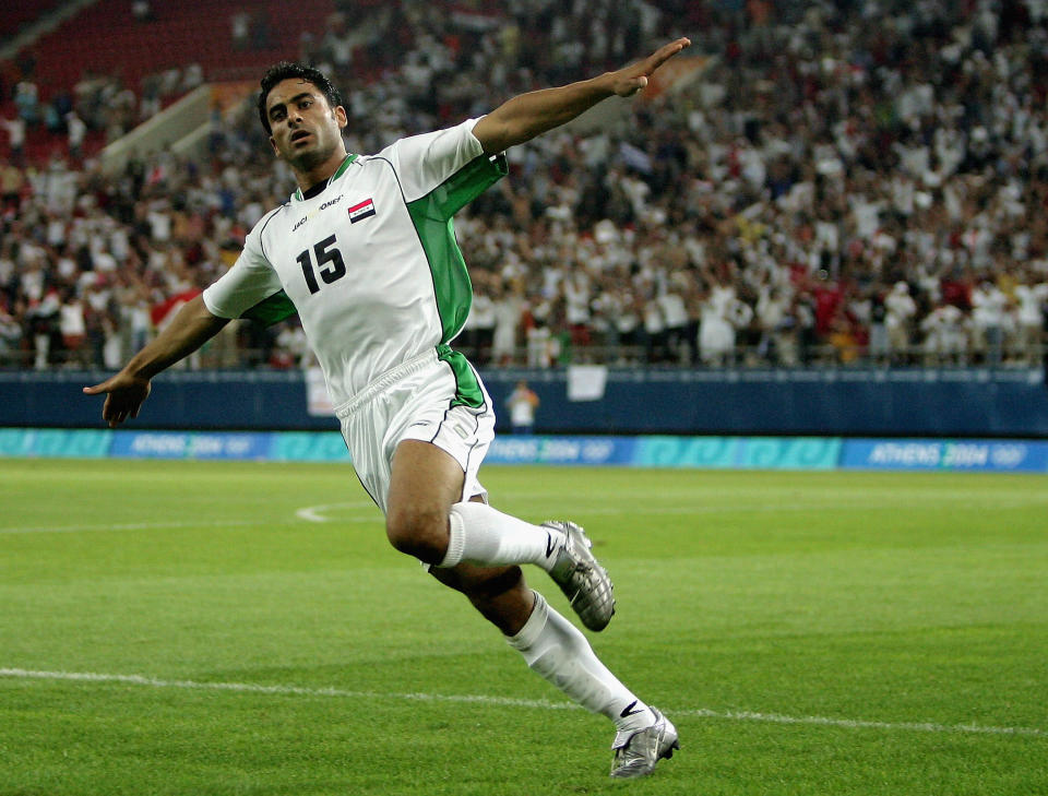 ATHENS - AUGUST 15: Karim Mahdi of Iraq celebrates scoring Iraq's second goal during the men's football preliminary match on August 15, 2004 during the Athens 2004 Summer Olympic Games at Karaiskaki Stadium in Athens, Greece. Iraq defeated Costa Rica 2-0. (Photo by Nick Laham/Getty Images)