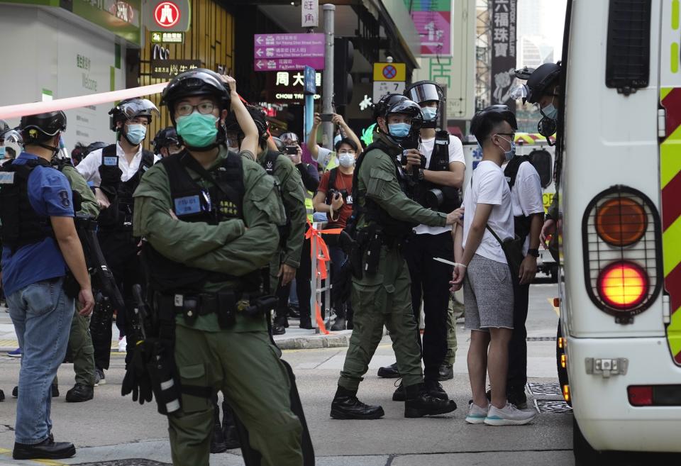 A man is arrested by police officers at a downtown street in Hong Kong Sunday, Sept. 6, 2020. About 30 people were arrested Sunday at protests against the government's decision to postpone elections for Hong Kong's legislature, police and a news report said. (AP Photo/Vincent Yu)