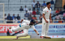 India's Cheteshwar Pujara dives to avoid being run out as Australia's Steve O'Keefe (R) watches. REUTERS/Adnan Abidi