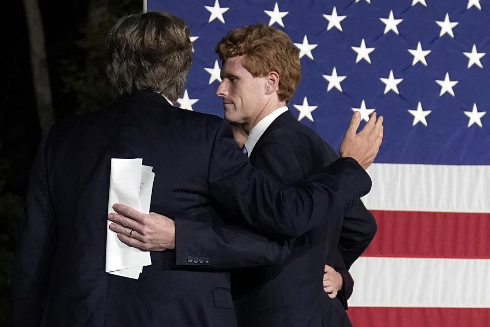 U.S. Rep. Joe Kennedy III looks to his brother Matthew, left, after speaking outside his campaign headquarters in Watertown, Mass., after conceding defeat to incumbent U.S. Sen. Edward Markey, Tuesday, Sept. 1, 2020, in the Massachusetts Democratic Senate primary. Listening at left are his twin brother Matthew and wife Lauren. (AP Photo/Charles Krupa)