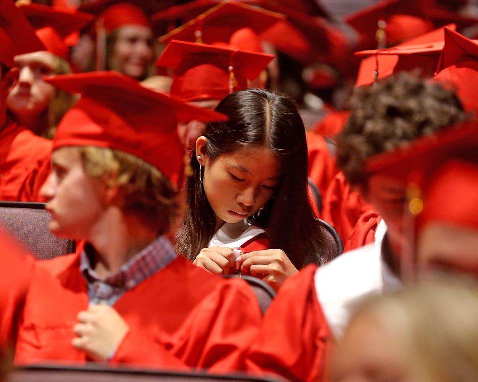 Hingham High senior Ashley Dong pins a medal to her robe before Hingham High’s graduation ceremony for the Class of 2023 on Saturday, June 3, 2023. Hingham High graduated 318 seniors. 