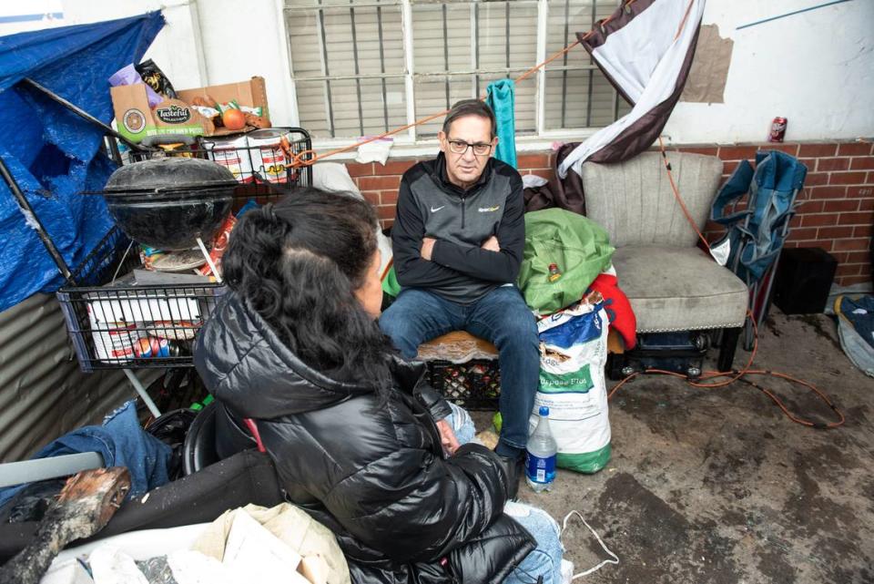 Modesto councilmember Nick Bavaro talks with homeless resident Denise Picanso in the Airport District in Modesto, Calif., Wednesday, March 29, 2023.
