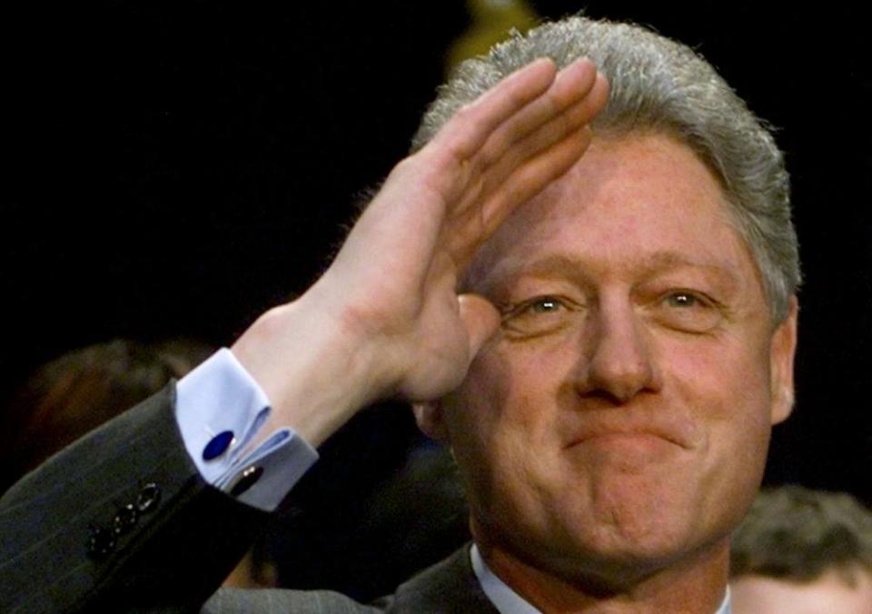 President Bill Clinton salutes a crowd in February 1999.