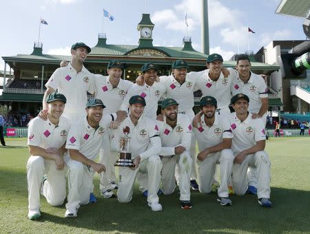 Australia's test cricket captain Steve Smith holds the Frank Worrell trophy among team mates after their third cricket test against the West Indies at the SCG in Sydney, January 7, 2016. REUTERS/Jason Reed