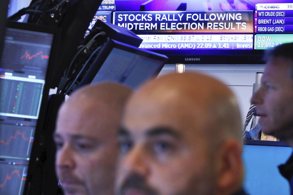 Traders work in a booth on the floor of the New York Stock Exchange, Wednesday, Nov. 7, 2018. Technology and health care stocks are leading indexes broadly higher on Wall Street as results of the midterm elections came in largely as investors had expected. (AP Photo/Richard Drew)