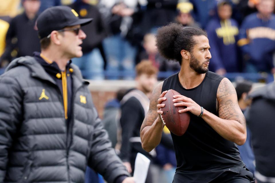 Michigan head coach Jim Harbaugh looks on as Colin Kaepernick passes during halftime at the Wolverines' spring game at Michigan Stadium.