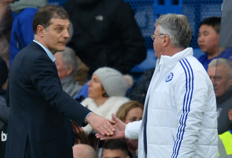 West Ham United manager Slaven Bilic (L) shakes hands with Chelsea's interim boss Guus Hiddink at the end of their sides' Premier League match at Stamford Bridge on March 19, 2016