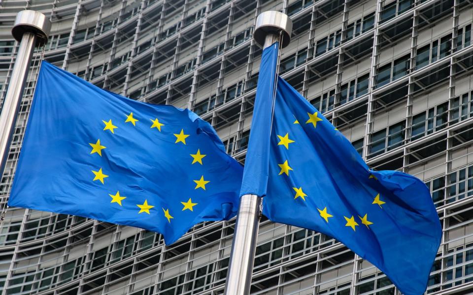 European Union flags fly outside the headquarters of the European Commission in Brussels 