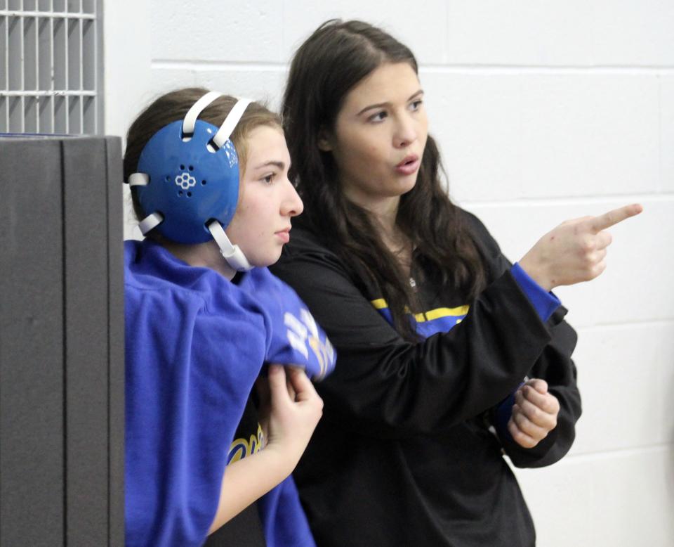 Olentangy girls wrestling coach Taryn Martin talks with Addison Ianniello during the Pioneer Classic on Saturday at Olentangy Orange.