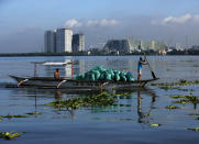 <p>Filipino fishermen on a boat maneuver amongst water lilies along Manila Bay in Paranaque city, Philippines, Oct. 1, 2016. According to state weather bureau, Philippine Atmospheric Geophysical and Astronomical Services Administration (PAGASA), Tropical Storm Chaba has entered Philippine Area of responsibility (PAR). Fisherfolk have been alerted on rough seas at the eastern seaboards of Luzon Island and residents have been informed on moderate to heavy rains. (Photo: EUGENIO LORETO/EPA)</p>