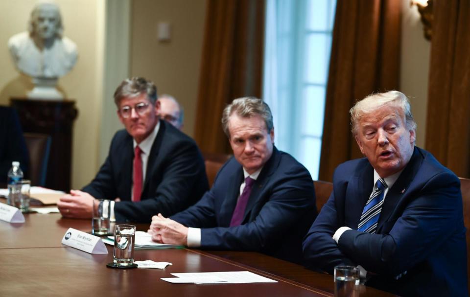 PHOTO: In this March 11, 2020 file photo, President Donald Trump speaks as CEO of Bank of America Brian Moynihan, center, and Chief Executive of Citigroup Michael Corbat look on during a meeting with banking leaders at the White House. (Brendan Smialowski/AFP via Getty Images, FILE)