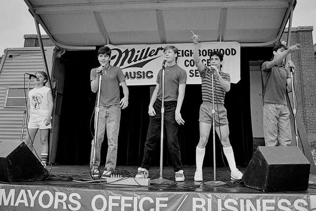 <p>John Nordell/Getty</p> New Kids on the Block's Joey McIntyre, Jordan Knight, Donnie Wahlberg, Danny Wood and Jordan Knight performing in Boston in July 1985