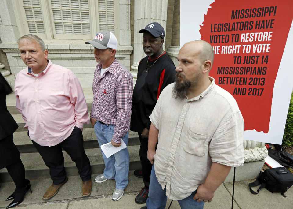 FILE - In this March 27, 2018, file photo, former convicts Wayne Kuhn, from left, Dennis Hopkins, Byron Coleman and Jon O'Neal hold a news conference in Jackson, Miss. A federal appeals court will hear arguments Tuesday, Dec. 3, 2019, on whether Mississippi laws that restrict the voting rights of certain felons are unconstitutional. Former convicted felons affected by the state's laws are pushing to have their voting rights restored. (AP Photo/Rogelio V. Solis, File)