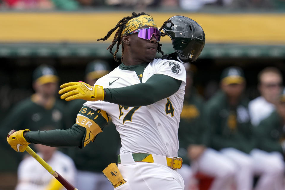 Oakland Athletics' Lawrence Butler loses his helmet while swinging at a pitch during the ninth inning of a baseball game against the Boston Red Sox, Wednesday, April 3, 2024, in Oakland, Calif. (AP Photo/Godofredo A. Vásquez)