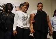 Lesley McSpadden (C), mother of Michael Brown who was killed in Ferguson, Missouri in August 9, 2014, bows her head in prayer with family member of people killed in police incidents during a news conference at the Reverend Al Sharpton's National Action Network in New York November 26, 2014. REUTERS/Shannon Stapleton