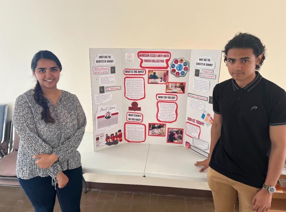 Gaganeet Kaur and Miran Kadri stand with a poster board outlining the Windsor-Essex Anti-Hate Youth Collective at the South Asian Centre of Windsor. 