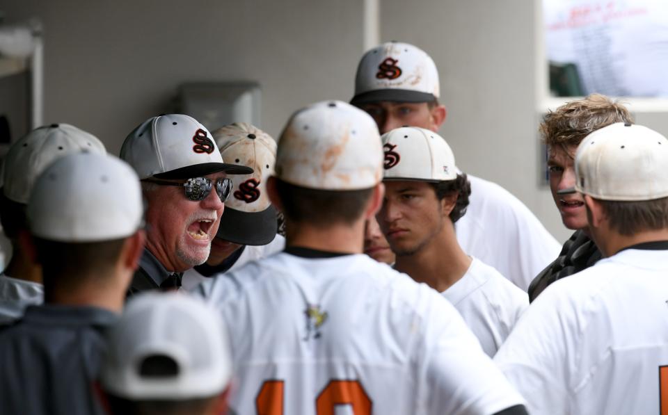 Sarasota High baseball coach Clyde Metcalf tries to get his team fired up during a Class 8A state semifinal game against Oviedo Hagerty High in Fort Myers on June 2, 2017.