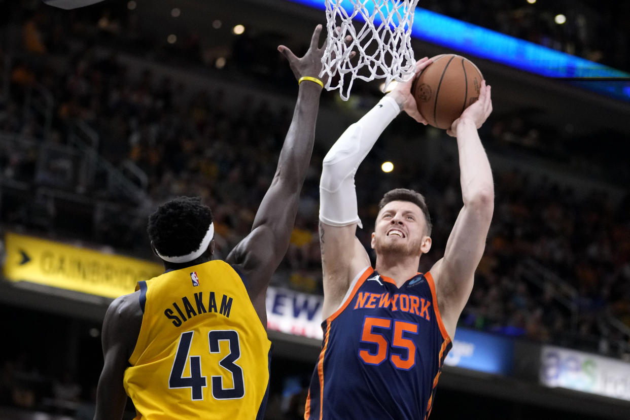 New York Knicks center Isaiah Hartenstein (55) shoots over Indiana Pacers forward Pascal Siakam (43) during the first half of Game 4 in an NBA basketball second-round playoff series, Sunday, May 12, 2024, in Indianapolis. (AP Photo/Michael Conroy)