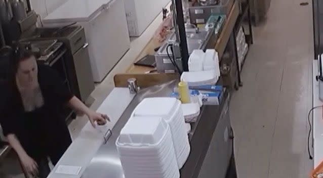 Footage shows the owner placing a white styrofoam cup on the bench. Photo: KXAN