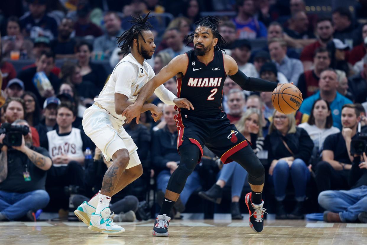 Miami Heat guard Gabe Vincent (2) plays against Cleveland Cavaliers guard Darius Garland during the first half of an NBA basketball game, Tuesday, Jan. 31, 2023, in Cleveland. (AP Photo/Ron Schwane)