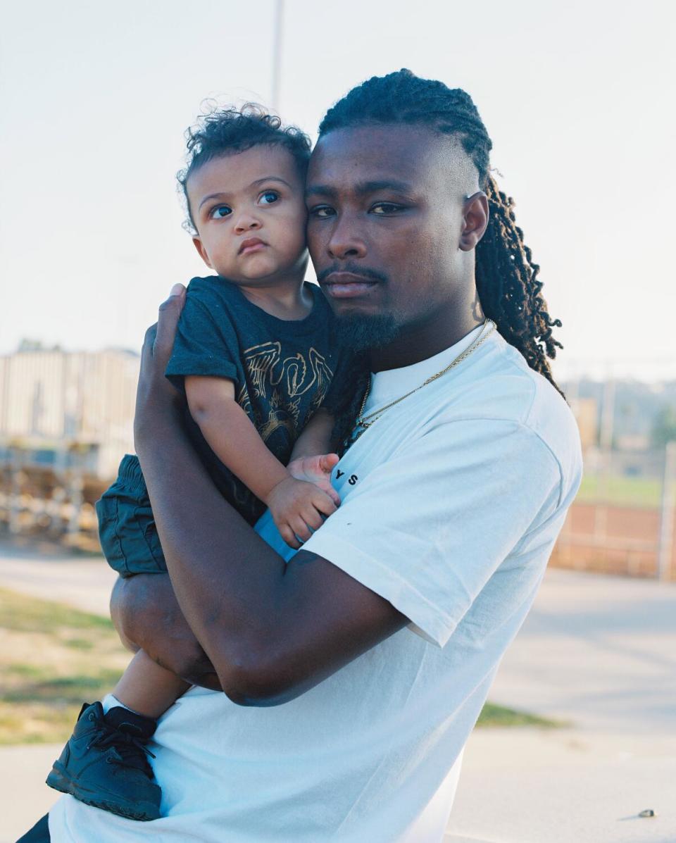 A man holds a baby in his arms.