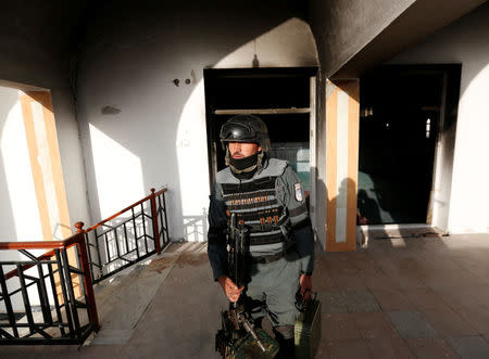 An Afghan policeman inspects a Shi'ite Muslim mosque after yesterday's attack in Kabul, Afghanistan August 26, 2017.REUTERS/Mohammad Ismail