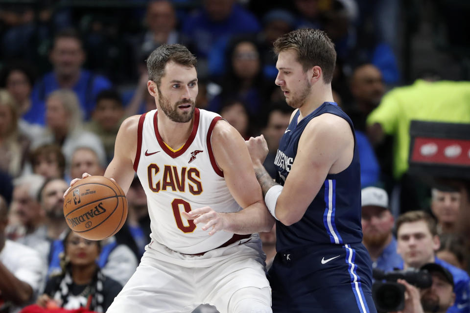 Cleveland Cavaliers forward Kevin Love (0) works against Dallas Mavericks forward Luka Doncic (77) for a shot opportunity in the first half of an NBA basketball game in Dallas, Friday, Nov. 22, 2019. (AP Photo/Tony Gutierrez)