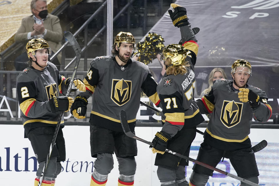 Vegas Golden Knights celebrate after defenseman Nicolas Hague, second from left, scored against the Los Angeles Kings during the second period of an NHL hockey game Monday, March 29, 2021, in Las Vegas. (AP Photo/John Locher)