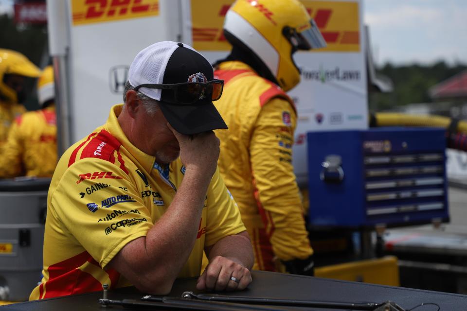 An exasperated Romain Grosjean crew member rubs his eyes near pitlane at Mid-Ohio.