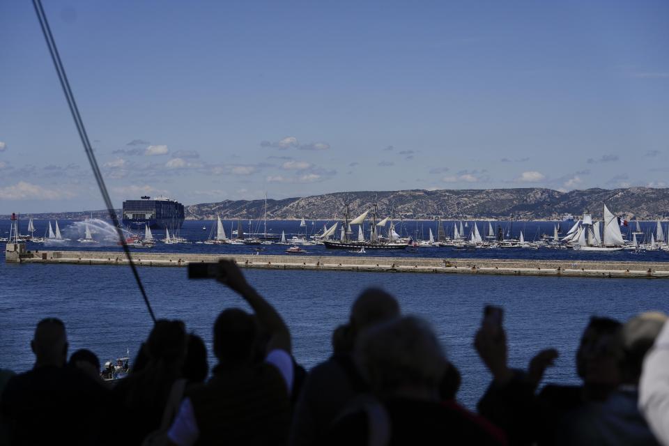 The Belem, the three-masted sailing ship which is carrying the Olympic flame, is accompanied by other boats approaching Marseille, southern France, Wednesday, May 8, 2024. After leaving Marseille, a vast relay route is undertaken before the torch odyssey ends on July 27 in Paris. The Paris 2024 Olympic Games will run from July 26 to Aug.11, 2024. (AP Photo/Thibault Camus)