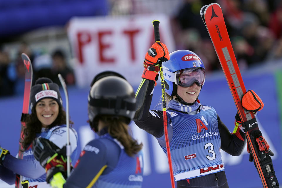 United States' Mikaela Shiffrin, right, celebrates winning an alpine ski, women's World Cup giant slalom race, as second-placed Italy's Federica Brignone, left, and third-placed Sweden's Sara Hector, smile, in Lienz, Austria, Thursday, Dec. 28, 2023. (AP Photo/Giovanni Auletta)