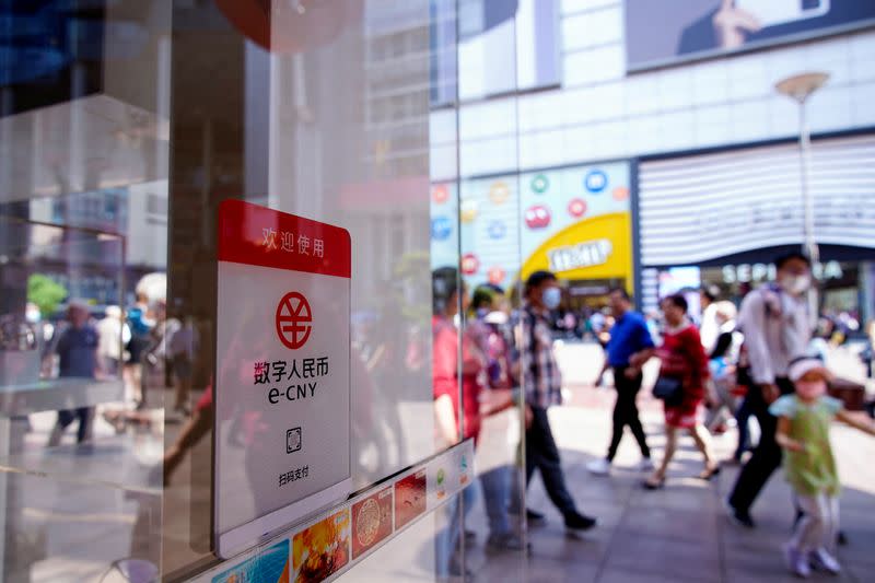 FILE PHOTO: A sign indicating digital yuan, also referred to as e-CNY, is pictured at a shopping mall in Shanghai
