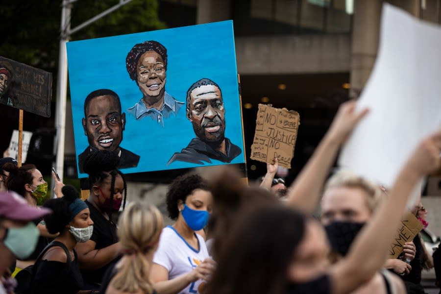 LOUISVILLE, KY – JUNE 05: Protesters carry a painting of (L-R) Ahmaud Arbery, Breonna Taylor and George Floyd while marching on June 5, 2020 in Louisville, Kentucky. Protests across the country continue into their second weekend after recent police-related incidents resulting in the deaths of African-Americans Breonna Taylor in Louisville and George Floyd in Minneapolis, (Photo by Brett Carlsen/Getty Images)