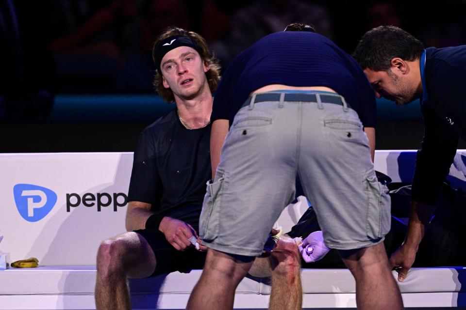 Andrey Rublev receives medical attention after hitting himself with his racket during a 7-5, 6-2 loss to Carlos Alcaraz at the ATP World Tour Finals in Turin, Italy,