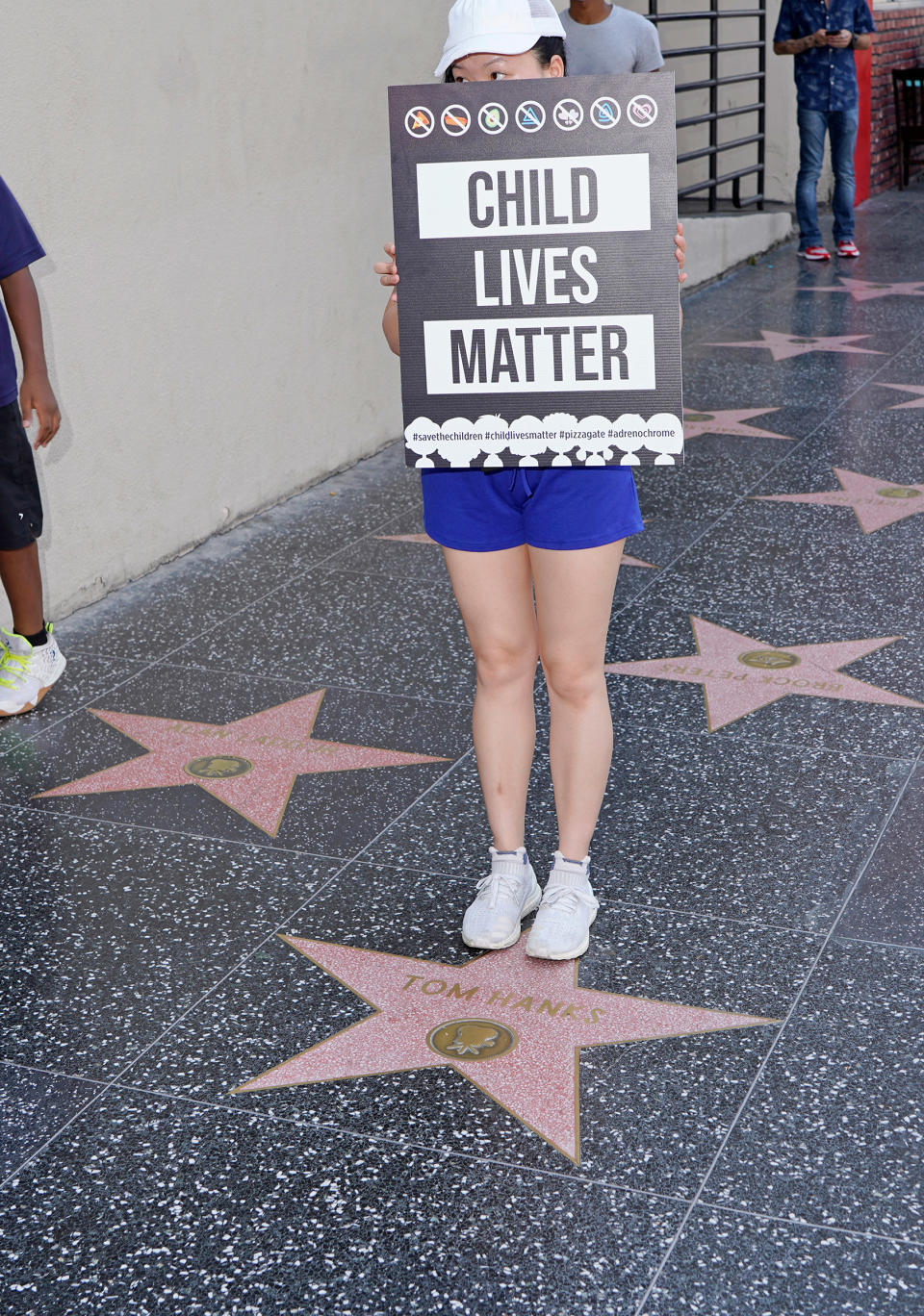 A protester stands on Tom Hanks' star on the Hollywood Walk of Fame, Aug. 22, 2020.<span class="copyright">Jamie Lee Curtis Taete</span>