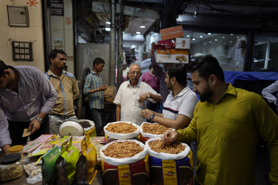 Small retailers shop for dry fruits in a wholesale market, in New Delhi, Monday, Oct. 10, 2022. A record drop in the rupee -- on top of higher raw material and shipping costs - has made the nuts much costlier for Indian consumers. (AP Photo/Manish Swarup)