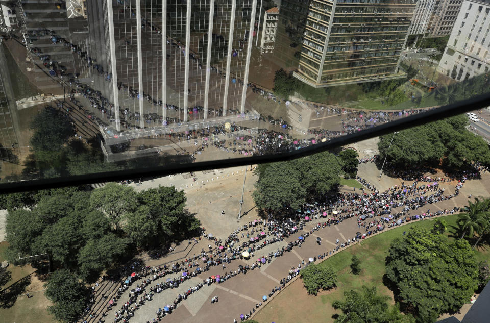 In this March 26, 2019 photo, unemployed line up to attend a job fair in downtown Sao Paulo, Brazil. The Getulio Vargas Foundation think tank published a study on Monday saying the average growth of the Brazilian economy between 2011 and 2020 could to be the worst since it started measuring in 1901, at 0.9 percent a year. (AP Photo/Andre Penner)