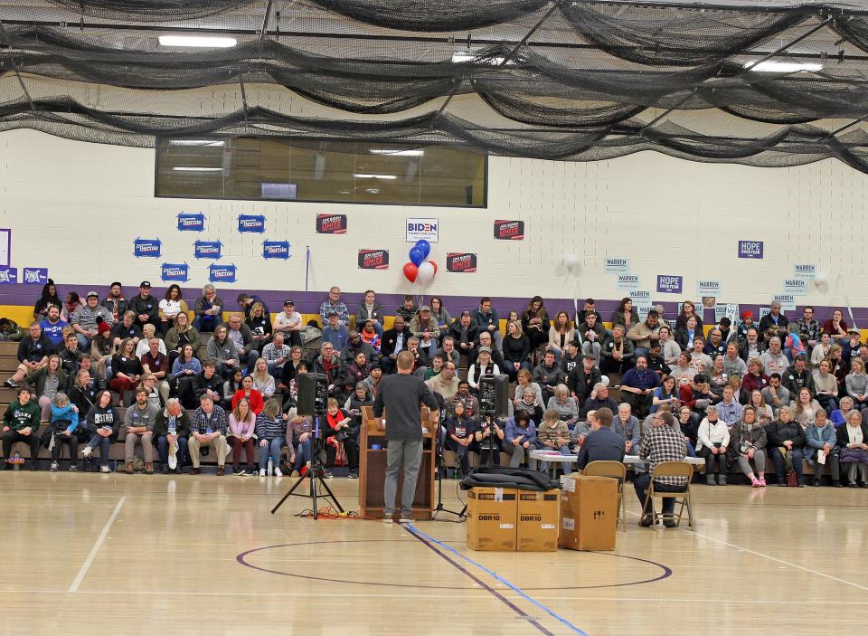 Precinct 2 Chair Tom Fey welcomes everyone as neighbors gather to discuss important issues while declaring their Presidential preference in a public meeting during the 2020 Iowa Democratic Party Caucus at Precinct 1 and 2 in the gymnasium at Johnston Middle School, 6501 NW 62nd Ave, in Johnston on Monday, February 3, 2020 as the eyes of the nation are focused on the state of Iowa as the caucuses are held at 1,678 precincts in Iowa and 92 satellite locations around the world as our country moves towards the general election in November.