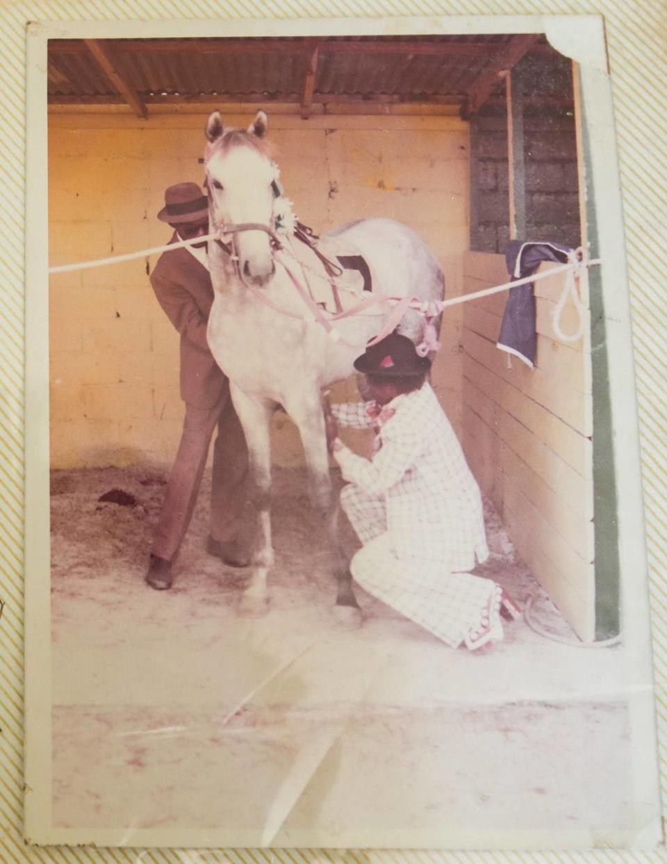 Larry Demeritte (right) with his father Thomas (left) prepare a horse for a race in the early 1970s in The Bahamas.