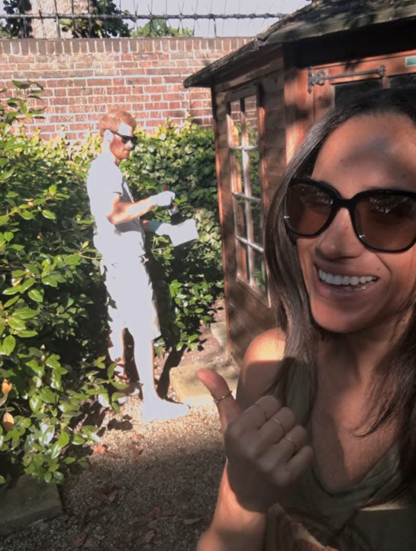 Meghan Markle takes a selfie with Prince Harry in the background at Nottingham Cottage