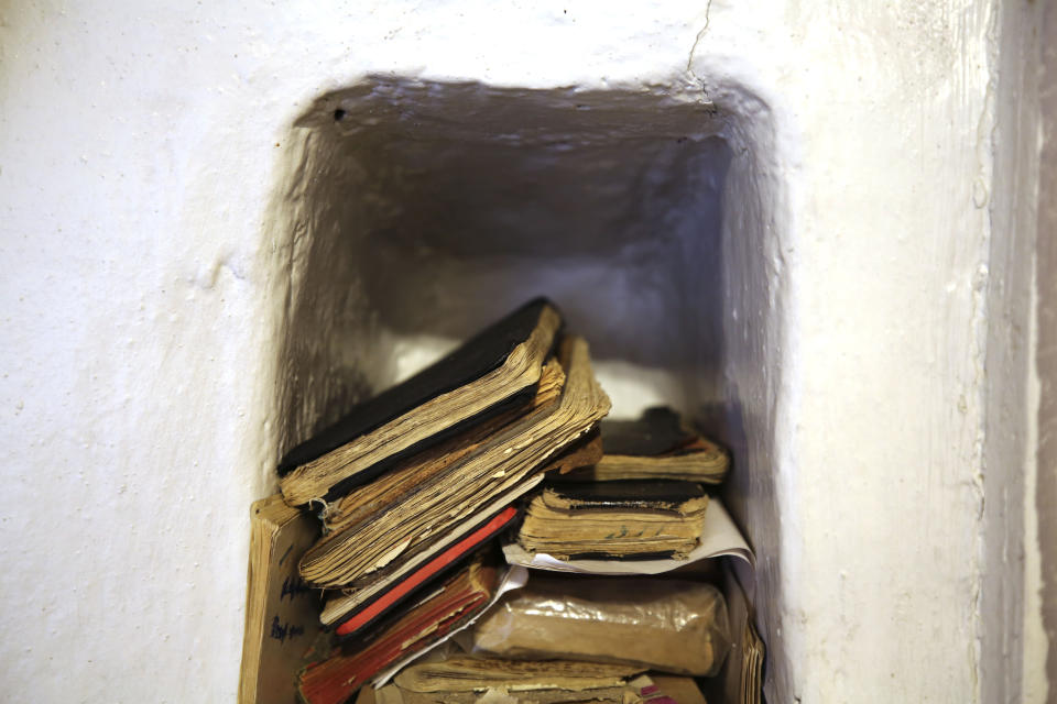 Handbooks of prayers and hymns, known as 'cuadernos', sit in a niche in the adobe wall of the morada de San Isidro, outside Holman, New Mexico, Saturday, April 15, 2023. Members of the brotherhood transmit their traditional devotions in New Mexican Spanish from generation to generation both verbally and through the notebooks, helping the unique dialect survive even as fewer people speak it. (AP Photo/Giovanna Dell’Orto)