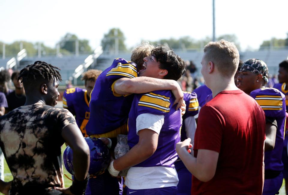 South Bend Clay senior Jeremy Cleveland, second from left, and junior Jose Duque hug following the Colonials' 54-0 win against North Newton Saturday, Sept. 30, 2023, at Clay Middle School in South Bend.