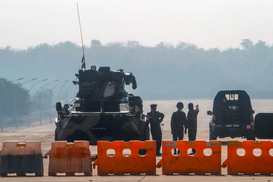Myanmar's military stand guard at a checkpoint manned with an armored vehicle in a road leading to the parliament building Tuesday, Feb. 2, 2021, in Naypyitaw, Myanmar.<span class="copyright">AP</span>