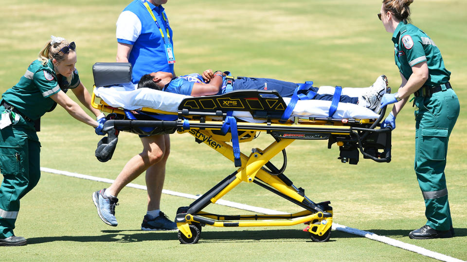 Achini Kulasuriya, pictured here being taken from the field on a stretcher.