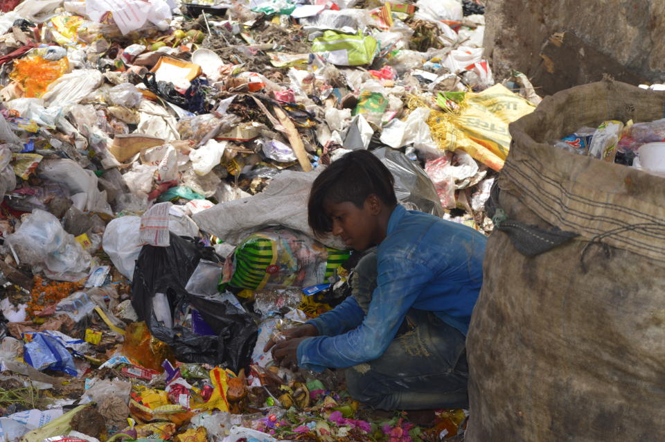 A wastepicker sorting through plastic waste in New Delhi. Much of India's recycling sector is informal. (Photo: Athar Parvaiz)