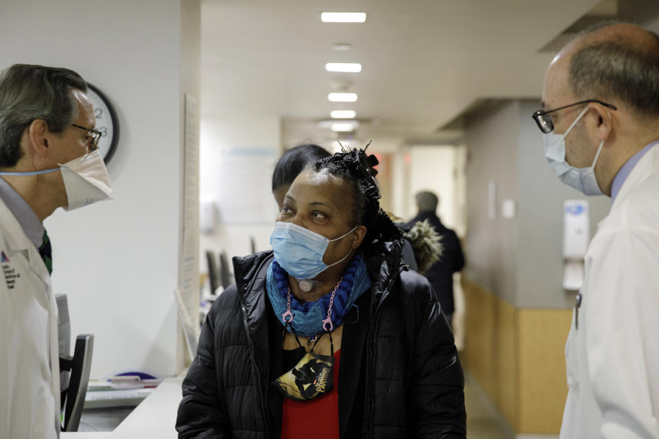 Trachea transplant recipient Sonia Sein talks with the lead surgeon of her procedure, Dr. Eric Genden, left, and Dr. Sandy Florman during a checkup visit at Mt. Sinai hospital in New York on Monday, March, 22, 2021. Doctors say this operation could help other people including COVID-19 patients left with serious windpipe damage from breathing machines. (AP Photo/Marshall Ritzel)